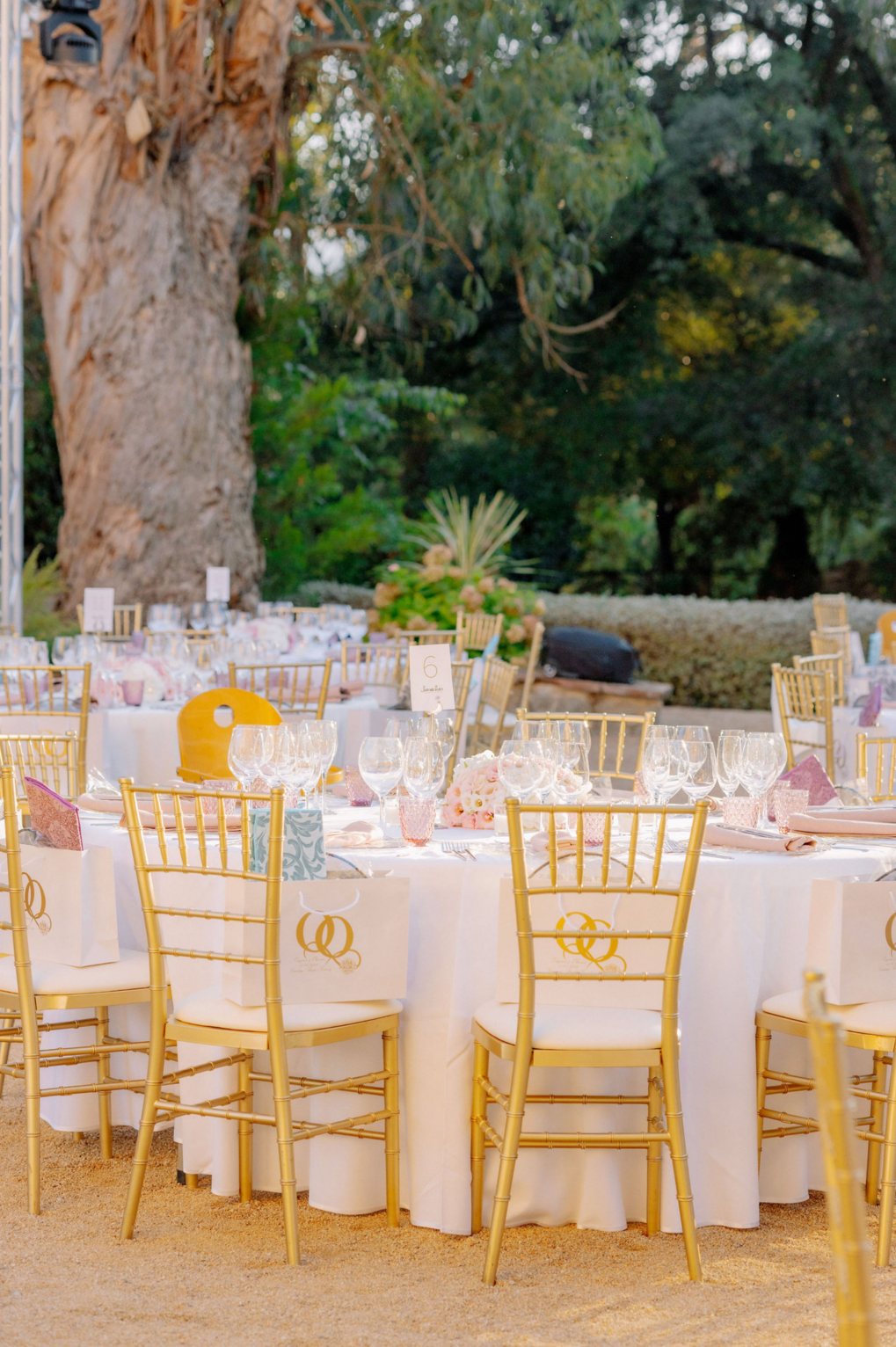 Gold chairs and wedding tables beneath a eucalyptus tree near Barcelona, Spain